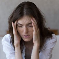 This woman's headache can be treated at our urgent care in Chalmette