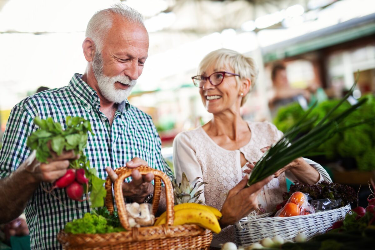 Elderly couple grocery shopping for fresh food