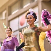 Two women in festive outfits celebrating Mardi Gras in New Orleans